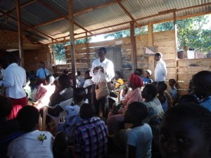 Mr.Charles Wadeya (parent's chairperson) holding bags for sale on Speech Day. The bags were made by students out of Banana fibres and blooms.